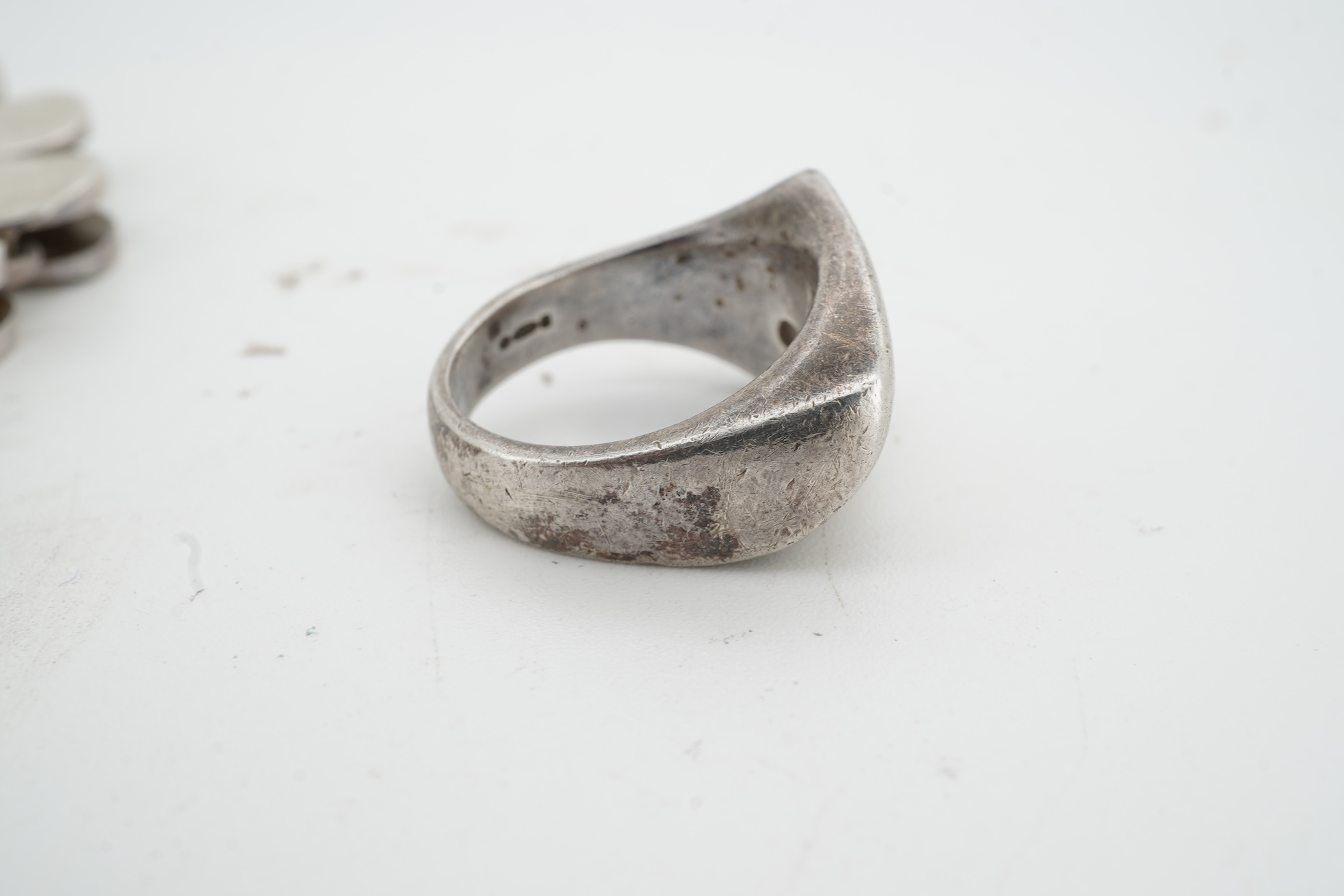 Nanna Ditzel for Georg Jensen, a silver bracelet, circa 1972, and a Georg Jensen ring, circa 1968, the bracelet composed of polished oval links with a concealed hoop clasp, length approximately 17cm, signed Georg Jensen,